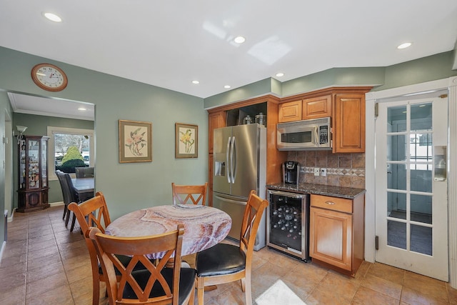 kitchen featuring wine cooler, stainless steel appliances, decorative backsplash, and recessed lighting