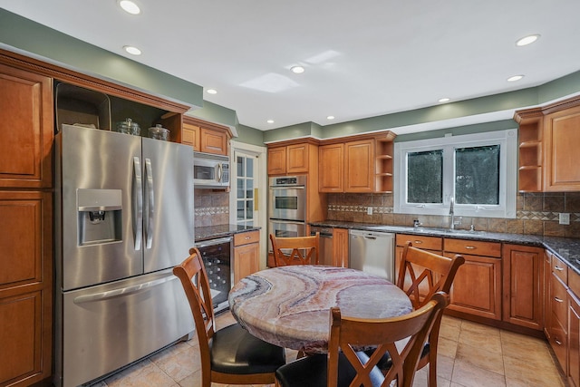 kitchen featuring wine cooler, stainless steel appliances, a sink, brown cabinets, and open shelves