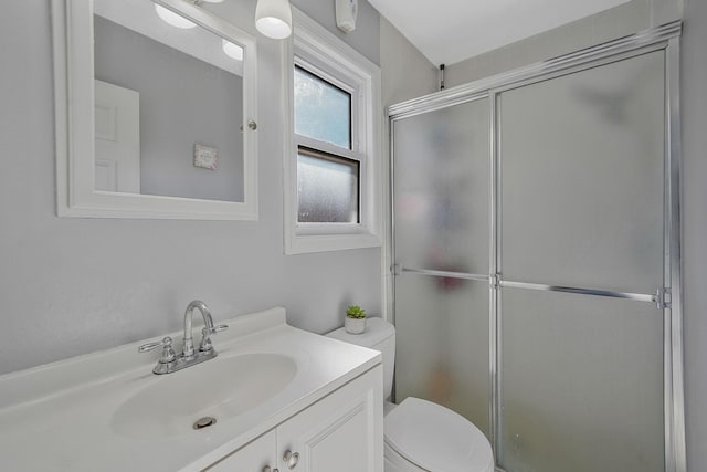 full bathroom featuring toilet, a shower stall, and vanity