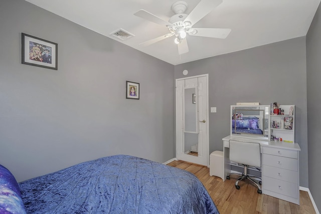 bedroom with light wood finished floors, a ceiling fan, visible vents, and baseboards