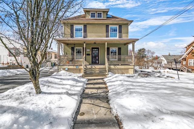 american foursquare style home with covered porch