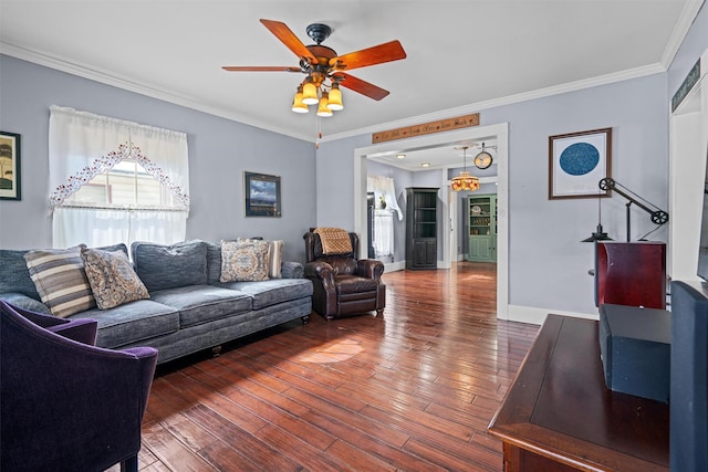 living area featuring a ceiling fan, wood-type flooring, baseboards, and crown molding