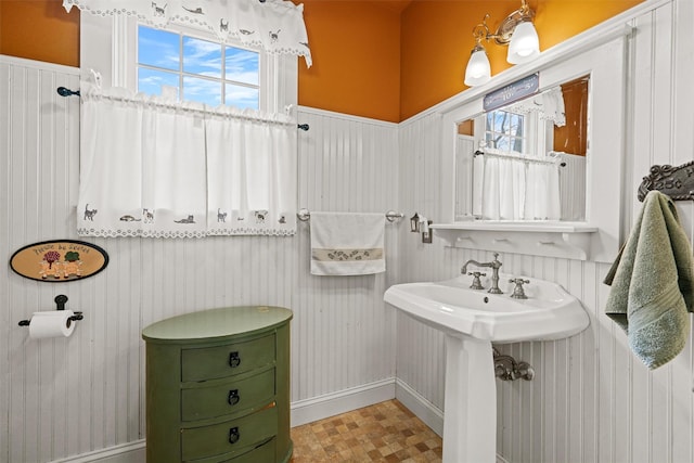 bathroom with a sink, a wealth of natural light, and tile patterned floors