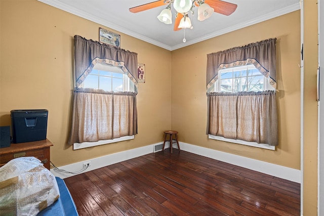 unfurnished bedroom featuring ornamental molding, hardwood / wood-style floors, a ceiling fan, and baseboards