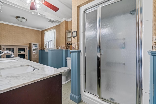 bathroom featuring ornamental molding, a stall shower, a sink, and wallpapered walls