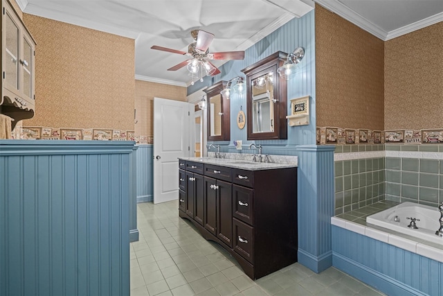 full bath featuring wallpapered walls, a wainscoted wall, a bath, double vanity, and crown molding