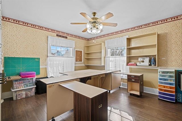 office area with baseboards, dark wood-type flooring, a ceiling fan, and wallpapered walls