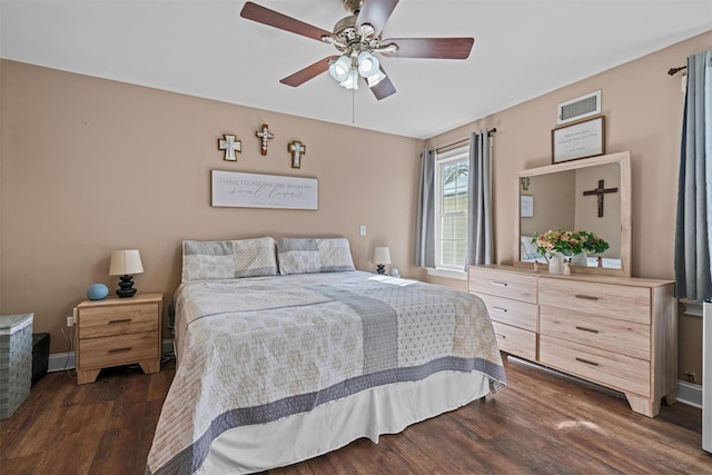 bedroom with ceiling fan, dark wood-style flooring, visible vents, and baseboards