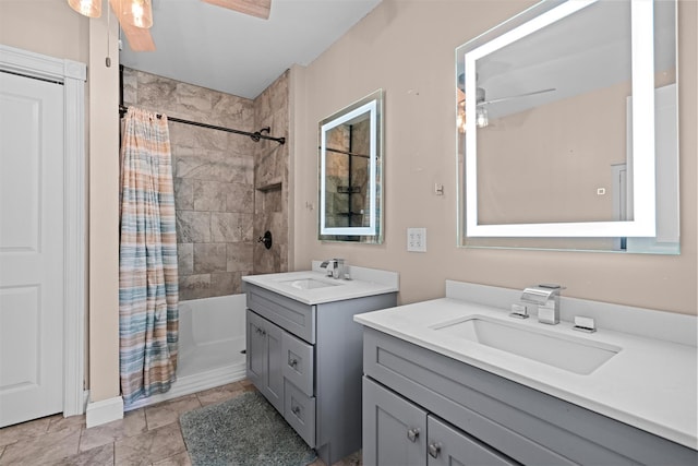 full bathroom featuring ceiling fan, shower / bath combo with shower curtain, two vanities, and a sink