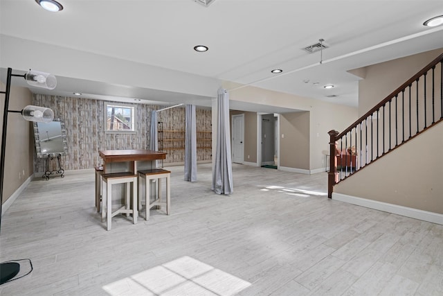 basement featuring recessed lighting, visible vents, light wood-style floors, baseboards, and stairs