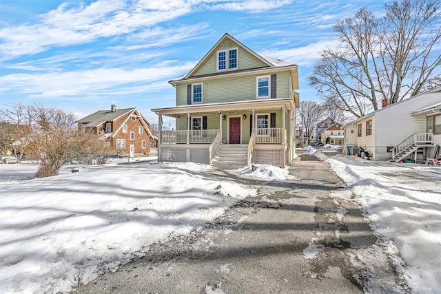 american foursquare style home with stairs and a porch