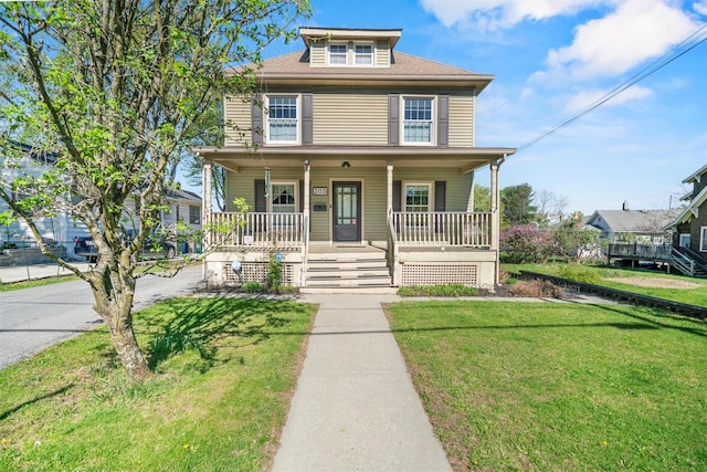 traditional style home with a front lawn and covered porch