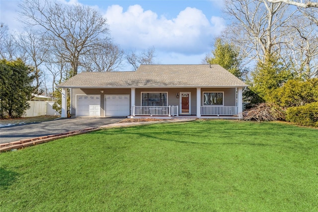 ranch-style house with a porch, a front yard, fence, a garage, and driveway