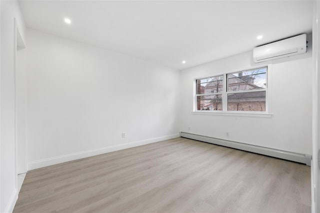 unfurnished room with a wall unit AC, recessed lighting, a baseboard heating unit, wood finished floors, and baseboards