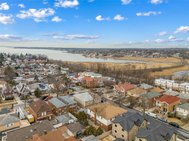 birds eye view of property with a water view and a residential view