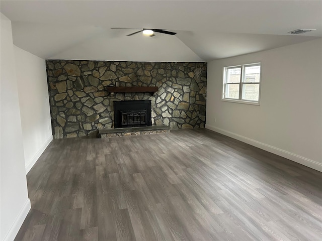 unfurnished living room featuring a fireplace, visible vents, vaulted ceiling, wood finished floors, and baseboards