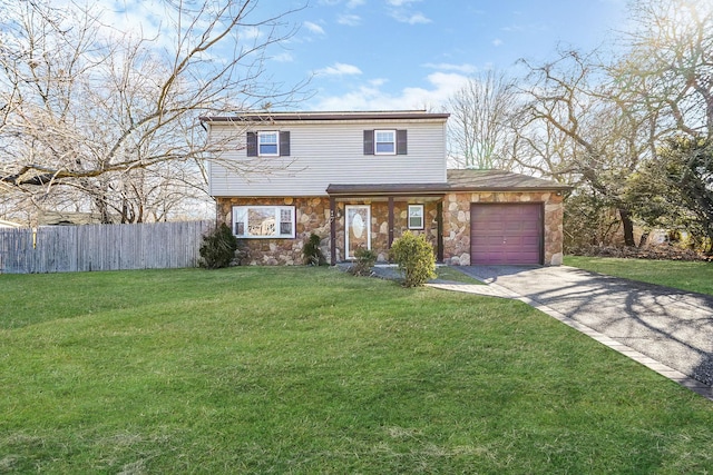 view of front of house with an attached garage, fence, driveway, stone siding, and a front yard