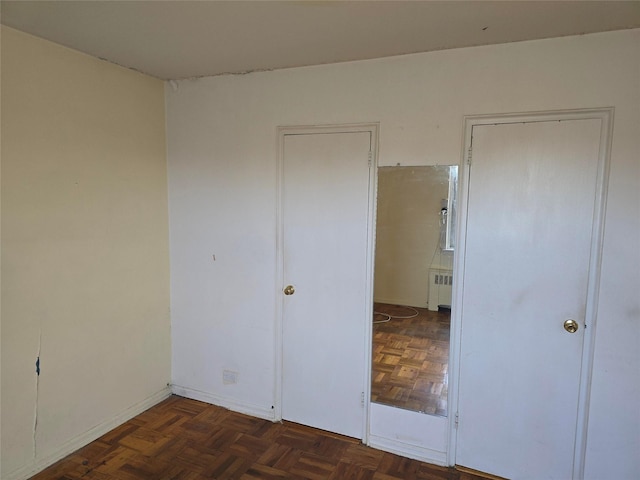 unfurnished bedroom featuring radiator heating unit