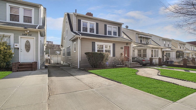 view of front of property featuring a chimney, entry steps, fence, a residential view, and an outdoor structure