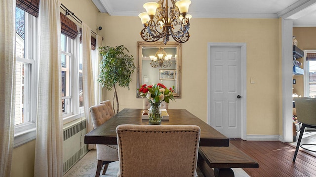 dining room featuring baseboards, radiator, ornamental molding, wood finished floors, and a chandelier