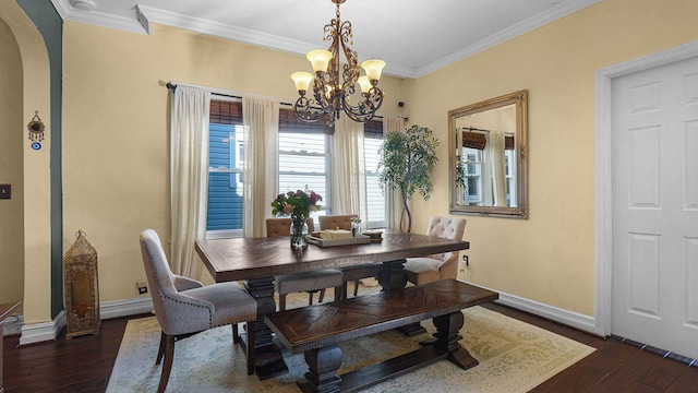 dining area featuring arched walkways, dark wood finished floors, and crown molding