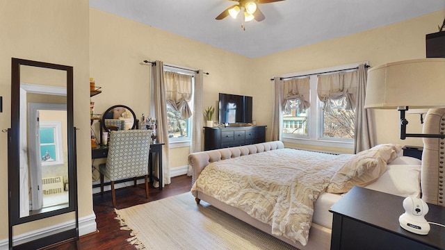 bedroom with ceiling fan, baseboards, and wood finished floors