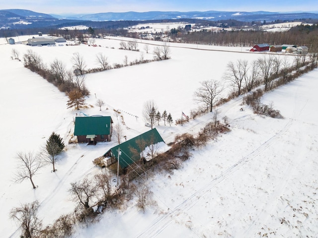 snowy aerial view with a mountain view