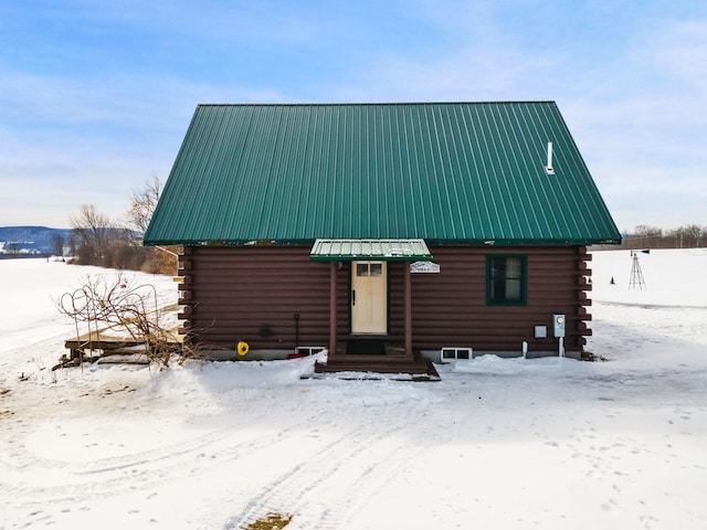 cabin featuring metal roof and log exterior