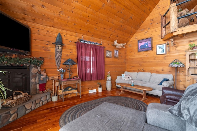 living room with a stone fireplace, wooden ceiling, wooden walls, vaulted ceiling, and hardwood / wood-style floors