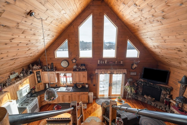 living area featuring wooden walls, wooden ceiling, high vaulted ceiling, and light wood-style flooring