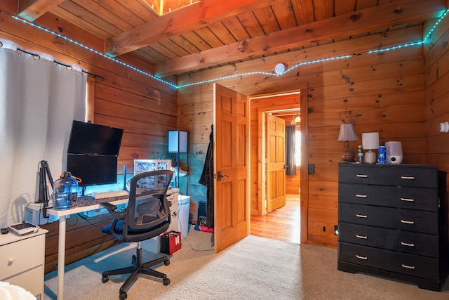 office area with beamed ceiling, wooden ceiling, carpet flooring, and wooden walls