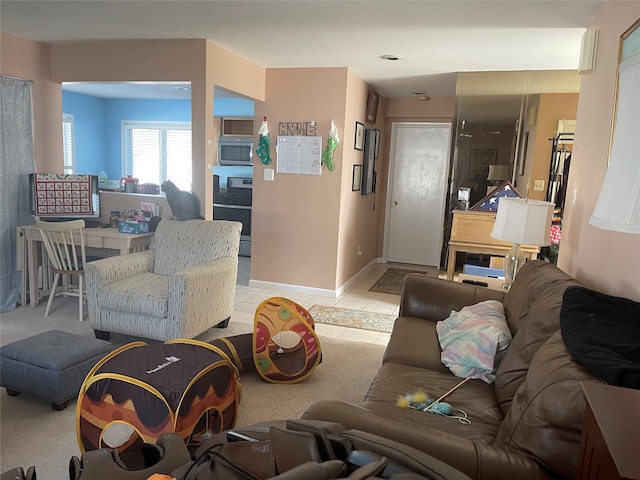 living room featuring baseboards and light tile patterned floors