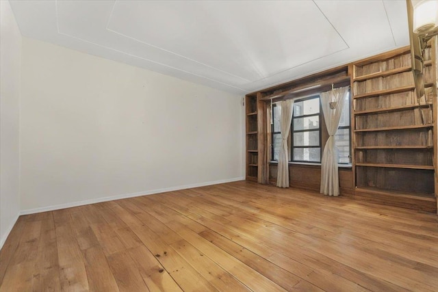 empty room with light wood-style floors and baseboards