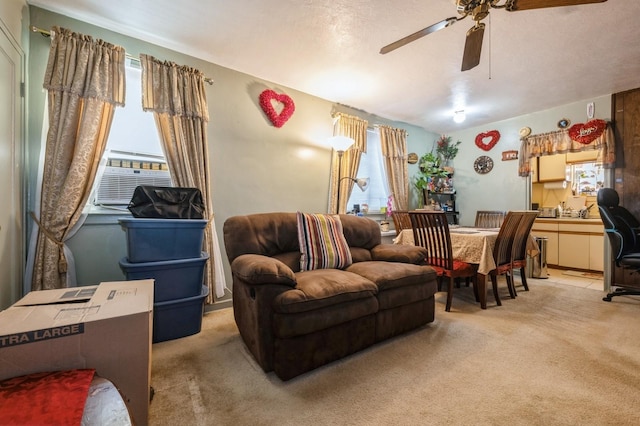 living room with plenty of natural light, cooling unit, a ceiling fan, and light colored carpet