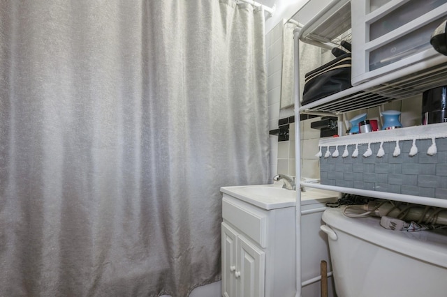 bathroom featuring toilet and vanity