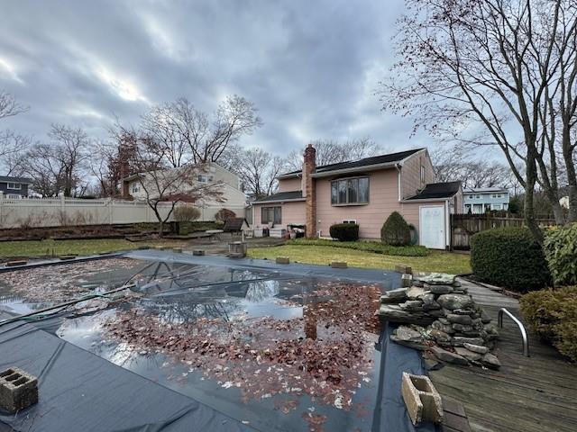 view of swimming pool with a fenced backyard, a fenced in pool, and a yard