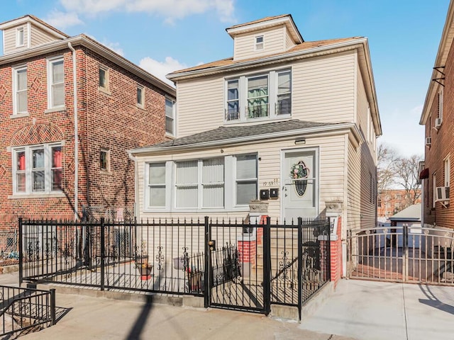 traditional style home with a fenced front yard and concrete driveway