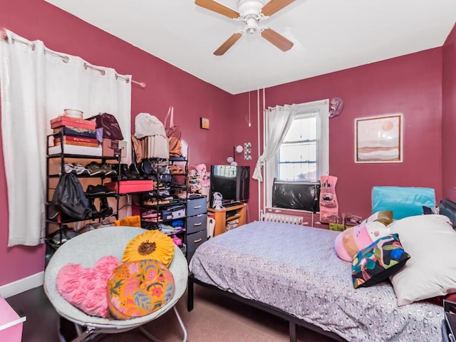 bedroom with baseboards and a ceiling fan