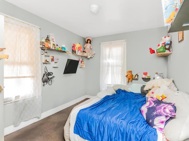 bedroom with multiple windows and baseboards