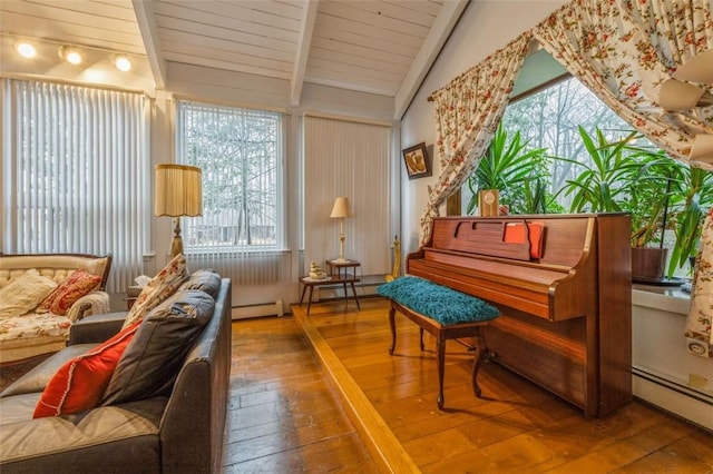 sitting room with a baseboard heating unit, wood-type flooring, and vaulted ceiling with beams