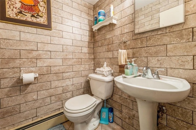 bathroom featuring baseboard heating and toilet