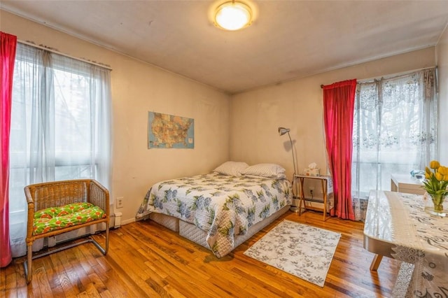 bedroom with hardwood / wood-style flooring