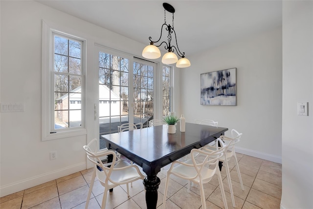 dining space featuring light tile patterned floors, baseboards, and a wealth of natural light