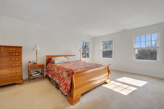 bedroom featuring light colored carpet, visible vents, and baseboards