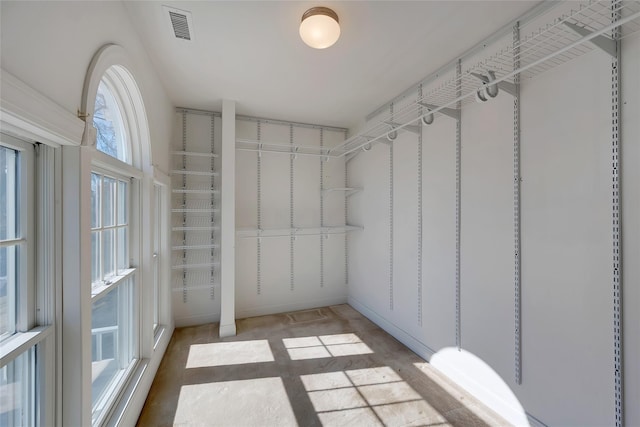 spacious closet featuring visible vents