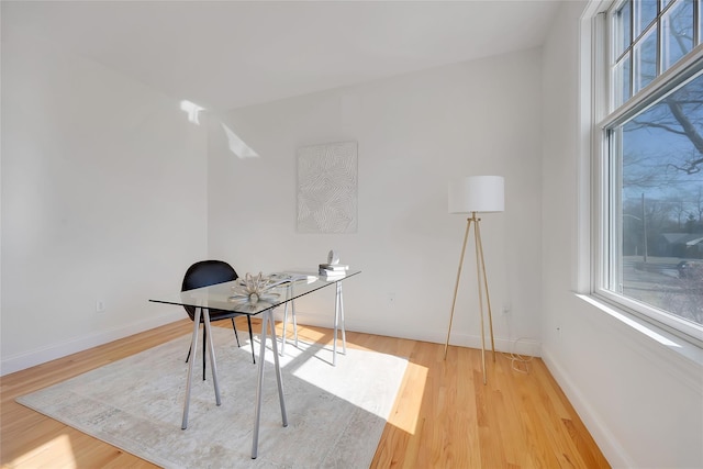 home office featuring light wood-style flooring and baseboards