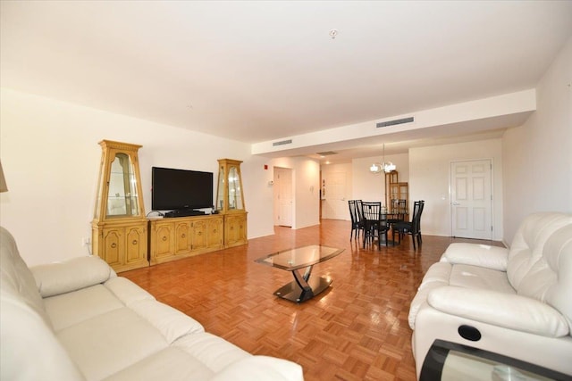 living area with visible vents and an inviting chandelier