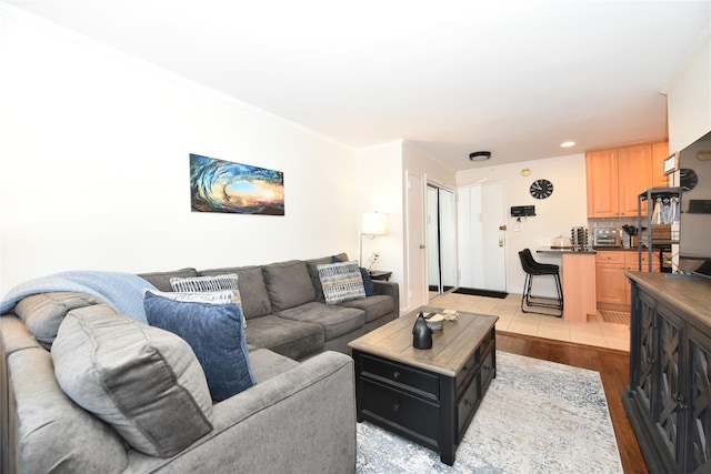 living room with light wood-style floors and recessed lighting