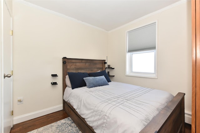 bedroom featuring baseboards, baseboard heating, crown molding, and wood finished floors