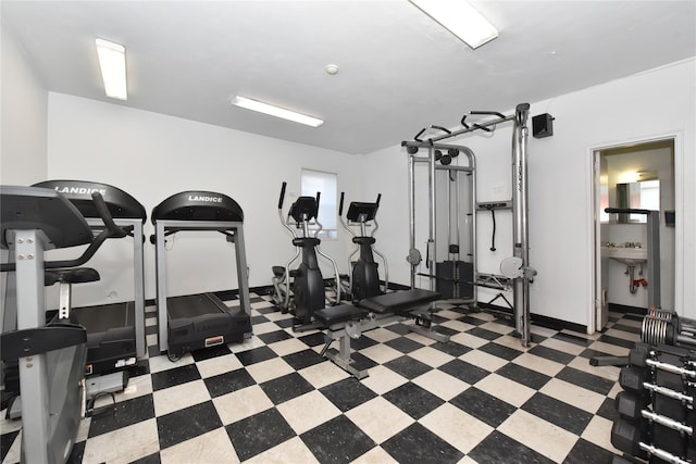 exercise room with tile patterned floors